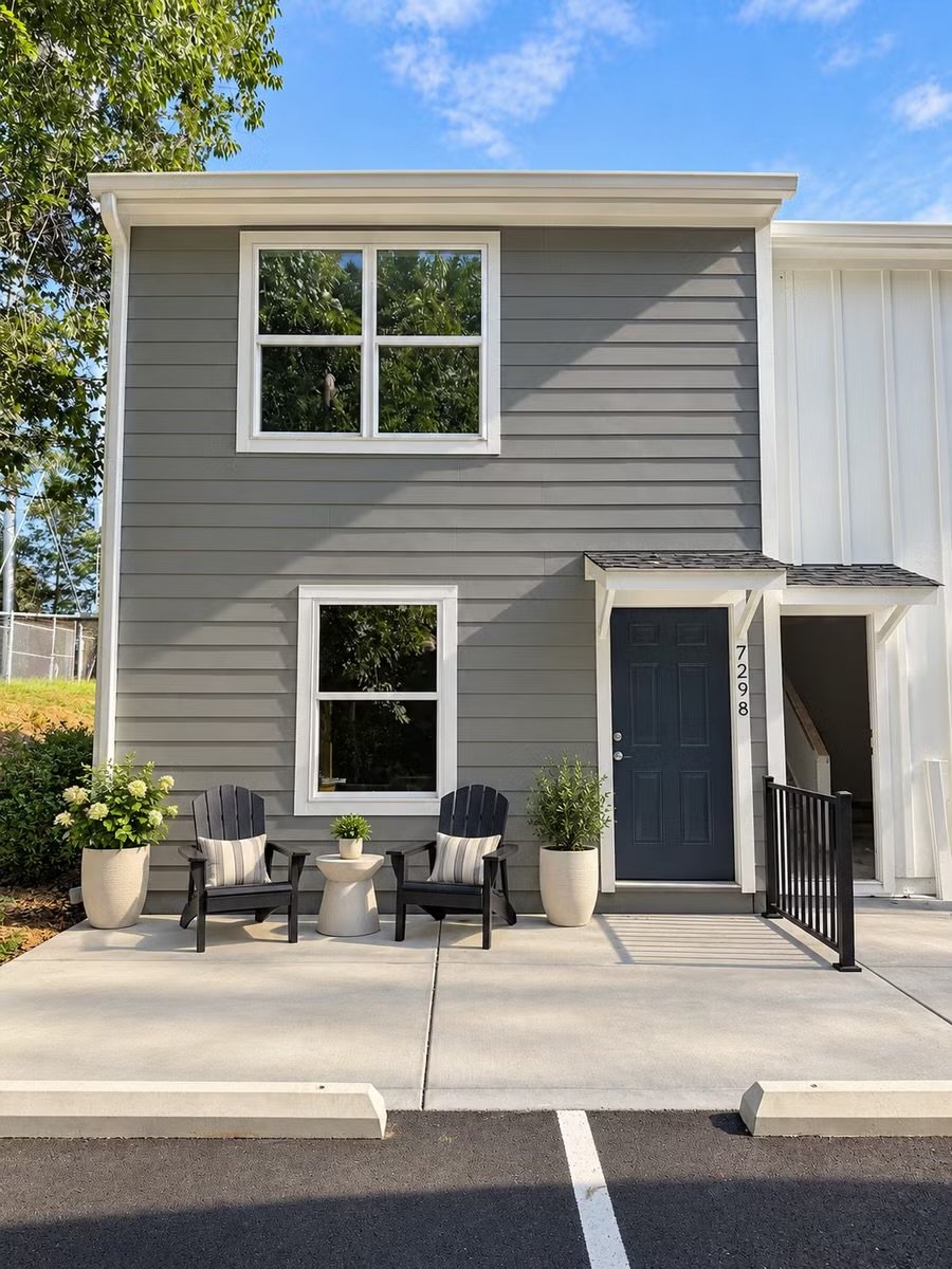 Front of a Courthouse Commons townhome with a private patio and navy front door